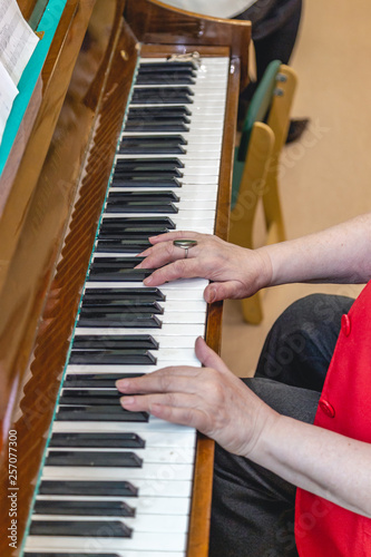 elderly woman playing the old piano