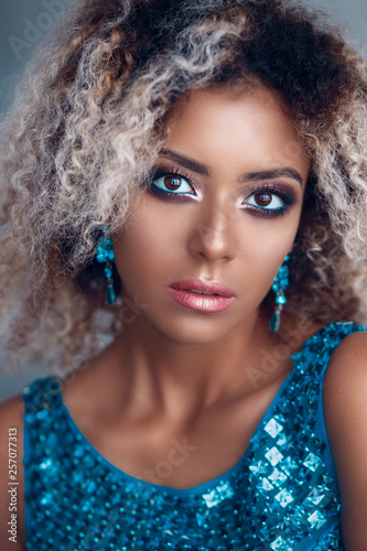 Close-up portrait of mixed woman with bright make-up