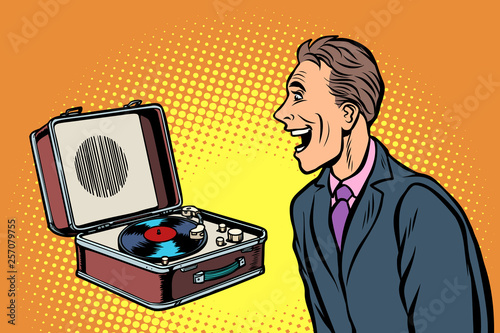happy man listening to music. retro vinyl record player