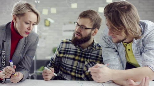 Business team of young consolidated people enjoying working together, millennials group talking having fun in cozy office, good relationships at work. They are happy to work together. They have a