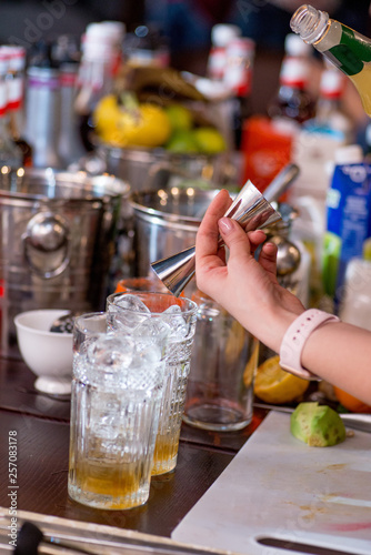 female bartender preparing cocktail in a cocktail bar
