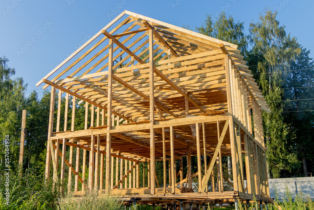 wooden interior frame of a new house under building, architectural residential construction stick built home framework. wooden interior frame of a new house under building, architectural residential construction stick built home framework.