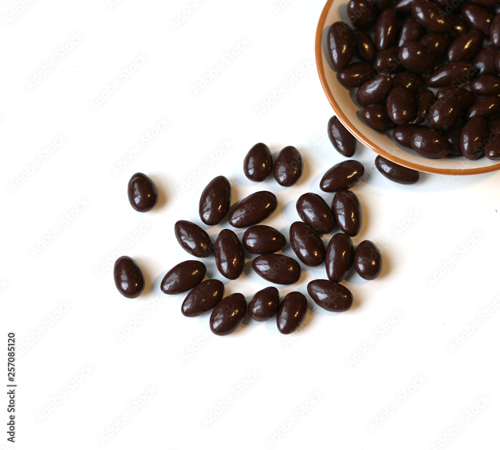 Food image close up candy, chocolate milk, extra dark almond nuts. Love Texture on white grey table top view background on the cup plate