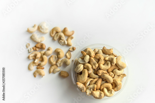 Healthy food for background image close up cashew nuts. Nuts texture on white grey table top view on the cup plate