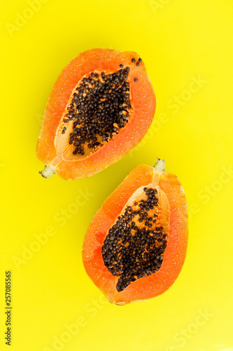 Half cut papaya on color background
