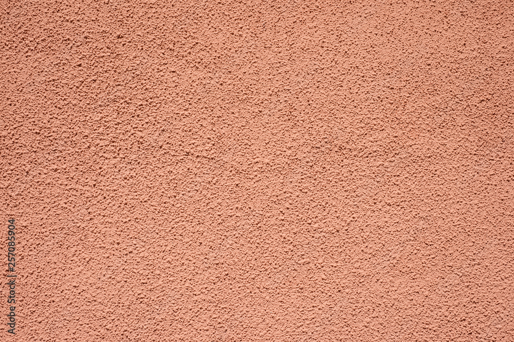 Fototapeta premium Plastered and painted terracotta wall for design, banner and layout.