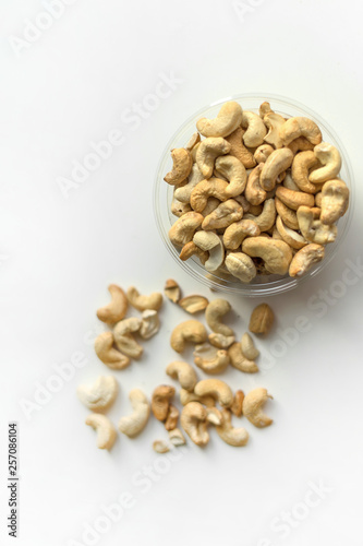 Healthy food for background image close up cashew nuts. Nuts texture on white grey table top view on the cup plate