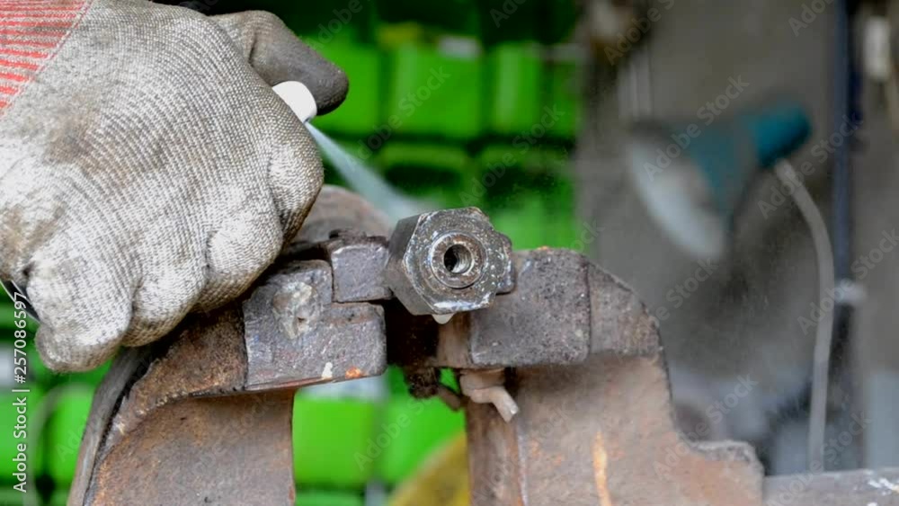 Removing rust from a used bolt and nut using a chemical agent.