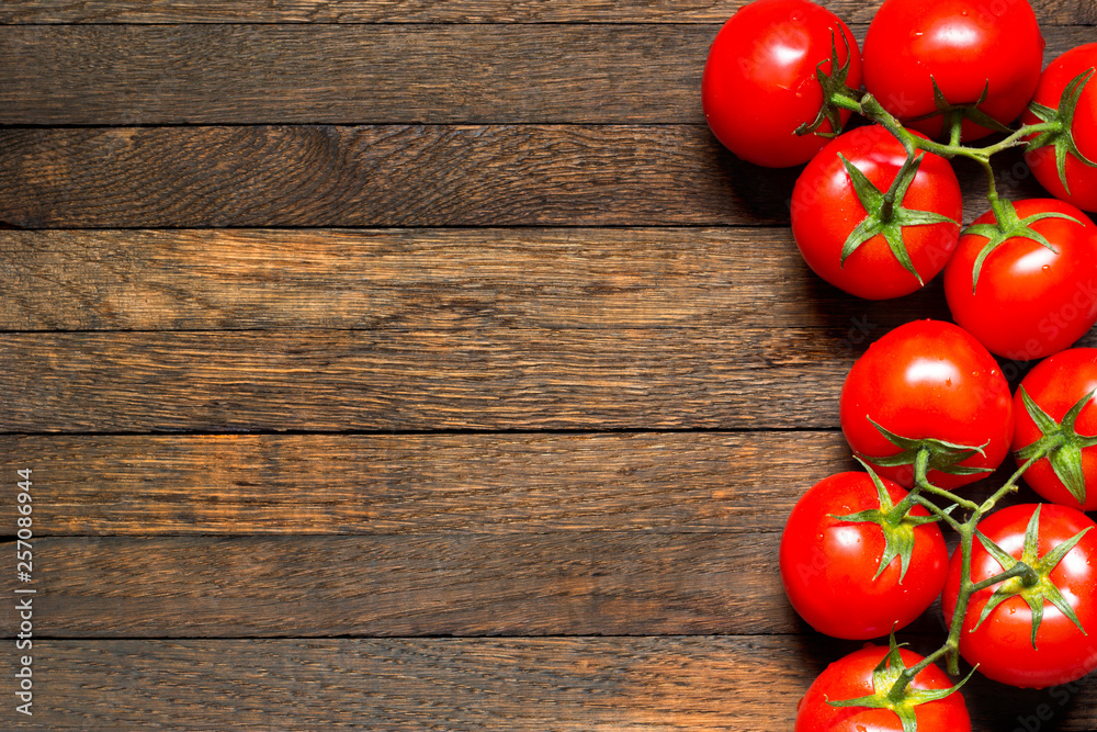 Wooden background with red tomatoes in right part and copy space in left Wooden background with red tomatoes in right part and copy space in left
