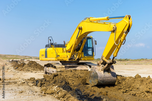 Yellow excavator in construction site