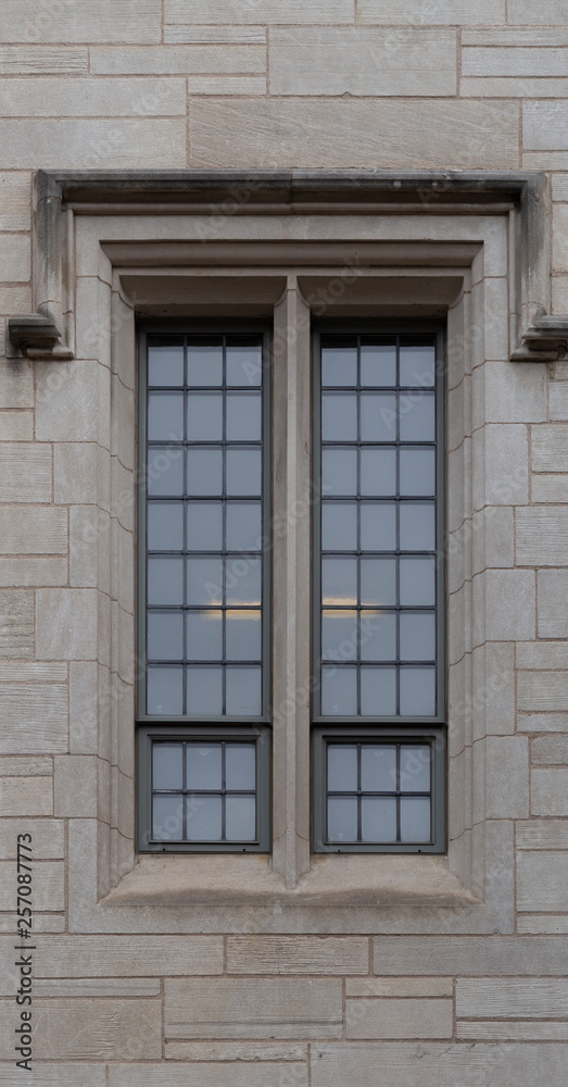 tall thin window on old cement brick building tall thin window on old cement brick building