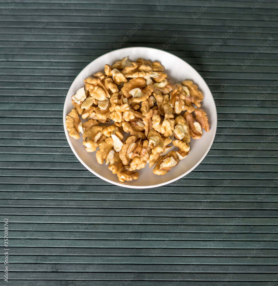 Healthy food for background image close up walnuts. Nuts texture on top view on the cup plate Healthy food for background image close up walnuts. Nuts texture on top view on the cup plate