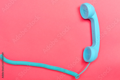 Retro phone on a pink paper background photo
