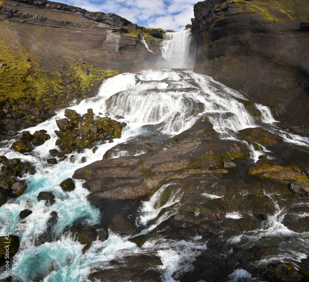 Panorama of Ofaerufoss waterfall in Eldgja Canyon in southern highlands of Iceland, as seen from the middle level.
