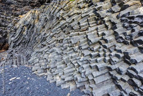 Hexagonal basalt cliffs of the bottom of Reynisfjall mountain in Southern Iceland. photo