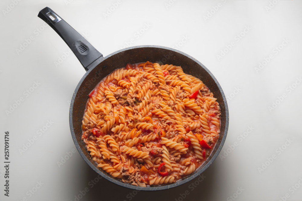 Cooked pasta in a pan white background Cooked pasta in a pan white background