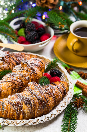 Chocolate Croissants for Breakfast with Christmas Theme Background. Selective focus.
