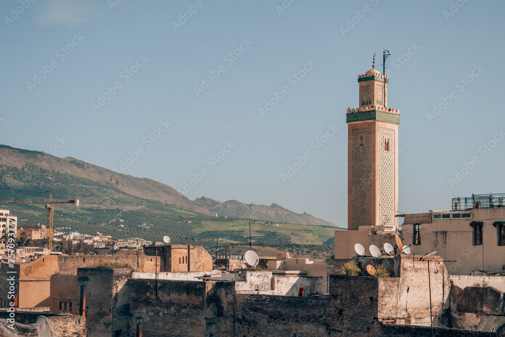 A view of the traditional houses of the medina and a typical muslim minaret in the northern moroccan city Fes.