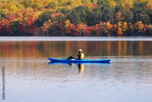 Kayaking in Lake with reflection of fall leaves.  