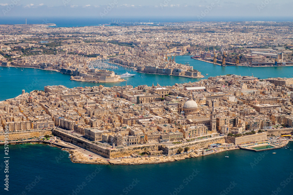Malta aerial view. Valetta, capital city of Malta, Grand Harbour, Senglea and Il-Birgu or Vittoriosa towns, Fort Ricasoli and Fort Saint Elmo from above. Marsaxlokk city and Freeport in background