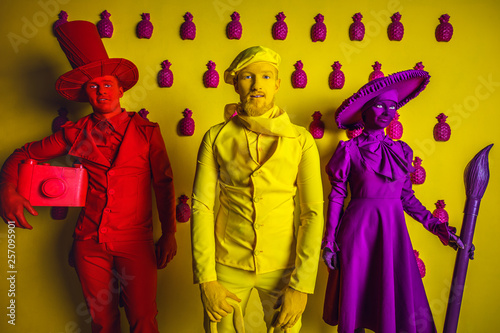 Group of stylized fantasy actors in scenic make-up and bright colored background. 