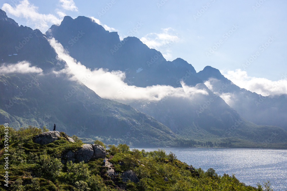 clouds over the mountains above the fjord in Lofoten in Norway