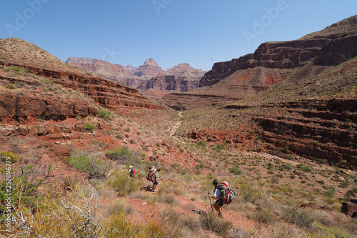 Backpackers descending the Tonto Trail in Mineral Canyon in Grand Canyon National Park, Arizona on a clear May morning.