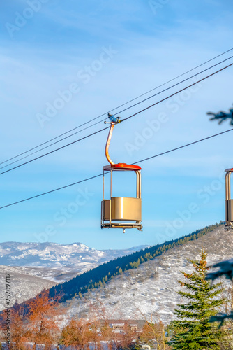 Ski lifts against mountain and sky on a snunny day