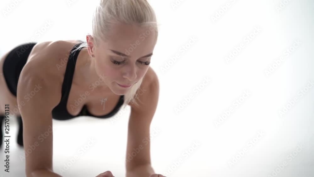 sporty girl doing plank exercise and laughing sporty girl doing plank exercise and laughing