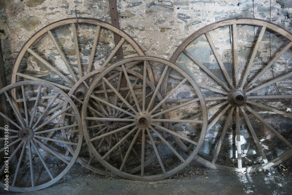 Antique Wagon Wheels Against an Old Stone Wall