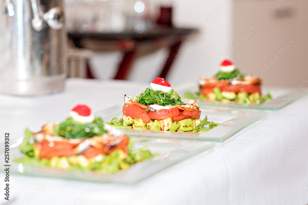 Beautiful table setting meal. Banquet. Red fish, canapes, food and snacks.