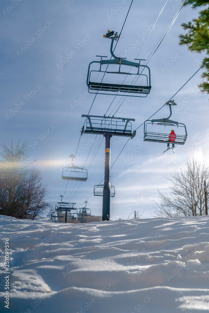 Sparkling sunlit snow under chair lifts and sky Sparkling sunlit snow under chair lifts and sky
