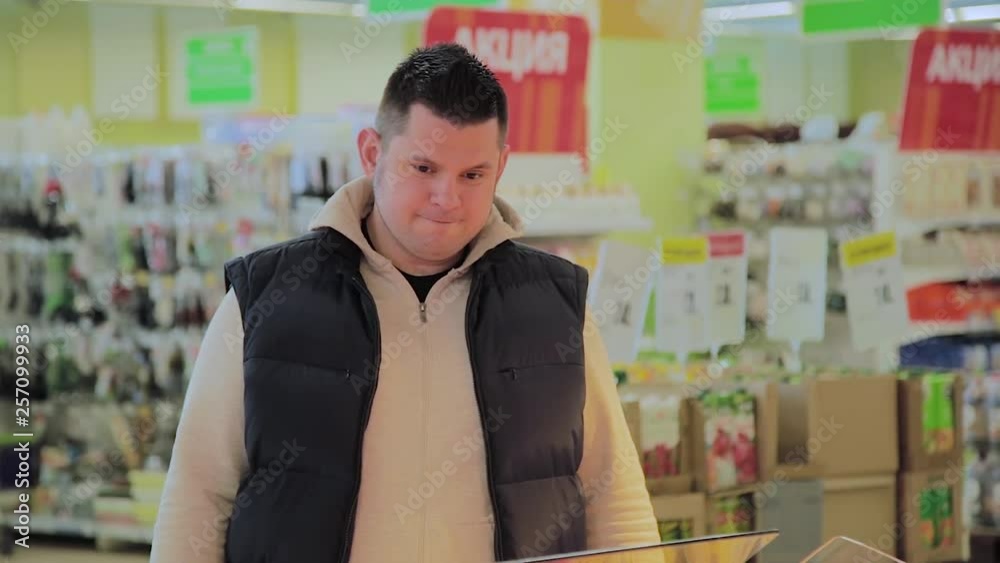Fat man in the supermarket chooses breakfast items for himself. Fat man in the supermarket chooses breakfast items for himself.