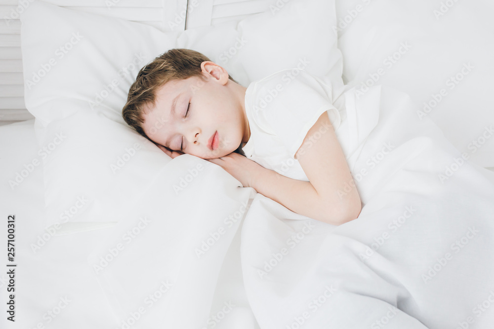 Cute boy sleeps in the morning in bed Cute boy sleeps in the morning in bed