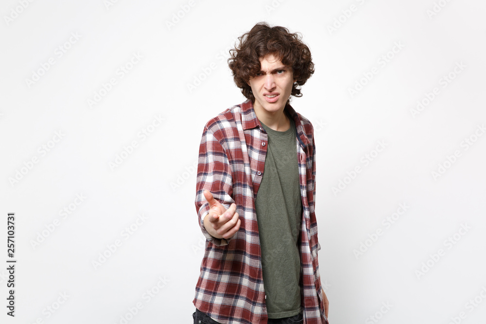 Portrait of bewildered disgusted young man in casual clothes pointing index finger on camera isolated on white wall background in studio. People sincere emotions lifestyle concept. Mock up copy space. Portrait of bewildered disgusted young man in casual clothes pointing index finger on camera isolated on white wall background in studio. People sincere emotions lifestyle concept. Mock up copy space.