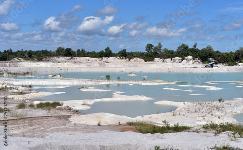 Man-made artificial lake Kaolin and white land containing kaolinite covered with rain water, forming clear blue lake, Air Raya Village, Belitung Island, Indonesia