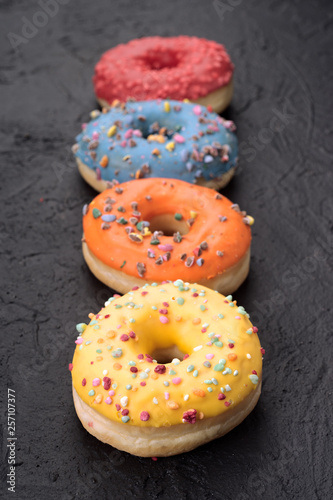 row of colored donuts on a textured base