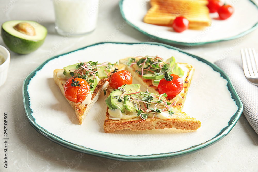Tasty toasts with avocado, sprouts and chia seeds on plate