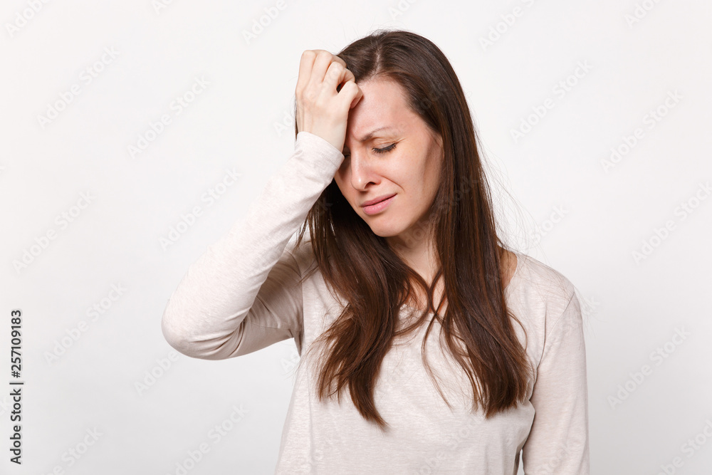 Tired crying disconcerted young woman in light clothes keeping eyes closed, putting hands on head isolated on white background in studio. People sincere emotions lifestyle concept. Mock up copy space. Tired crying disconcerted young woman in light clothes keeping eyes closed, putting hands on head isolated on white background in studio. People sincere emotions lifestyle concept. Mock up copy space.