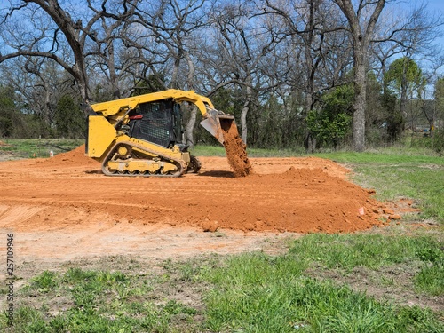 Skid Steer Loader Dumping Dirt