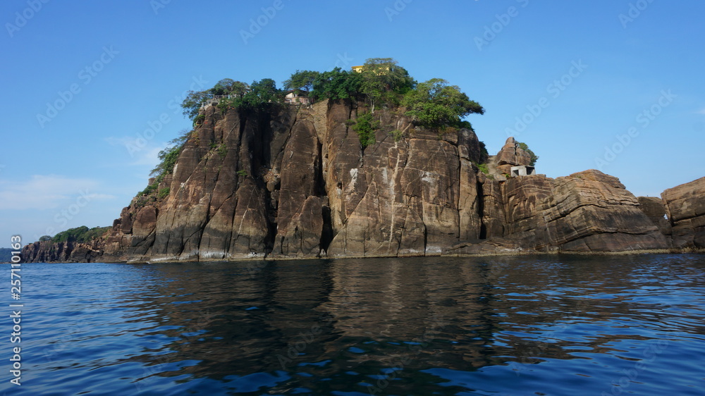 Rock in the indian ocean with a hindu temple on top in Trincomale