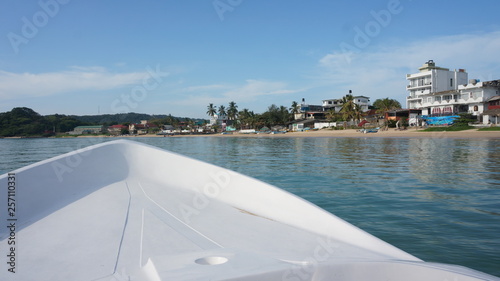 Viewing dryland from a white ship bow