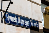 Warsaw, Poland New town historic road during sunny summer day morning with closeup of street sign and text for Rynek Nowego Miasta in Polish