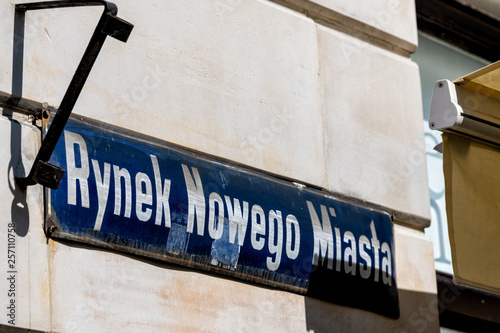 Warsaw, Poland New town historic road during sunny summer day morning with closeup of street sign and text for Rynek Nowego Miasta in Polish