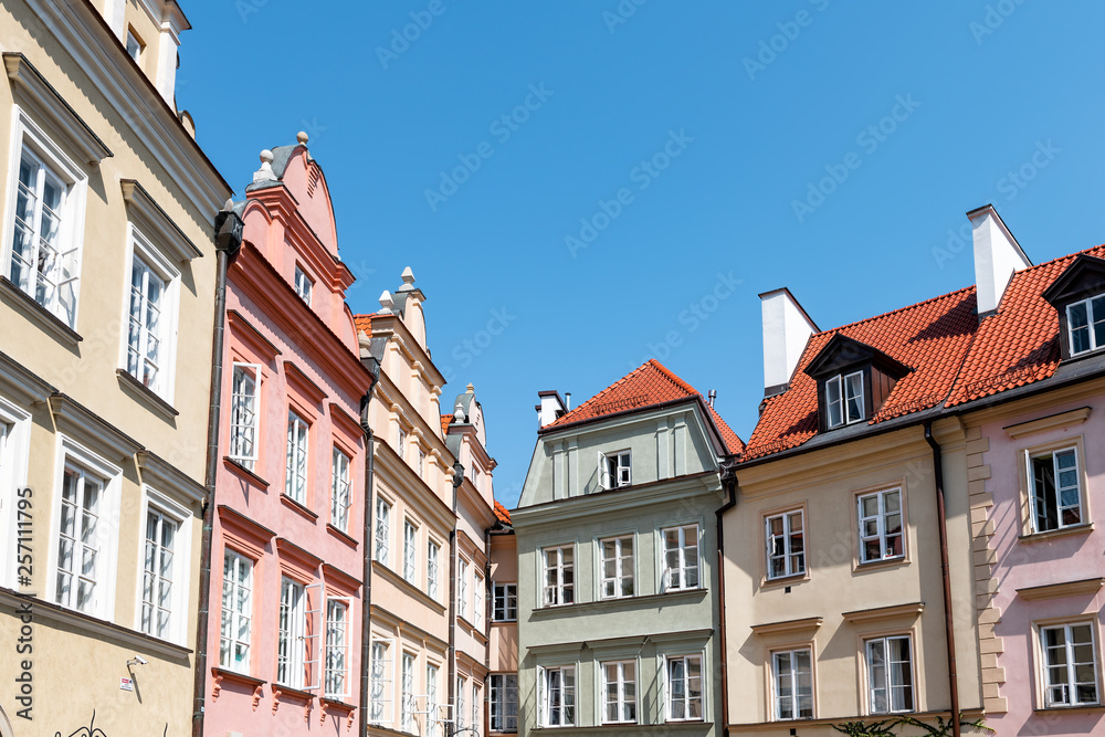 Warsaw, Poland Old town square with historic street town architecture and windows multicolored pattern of pink and yellow vintage color buildings