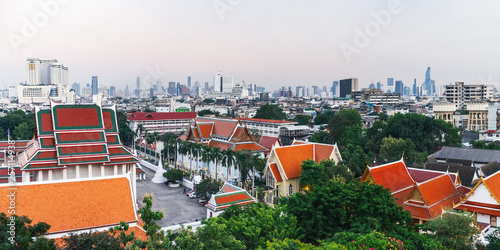 Panorama view of Bangkok from Golden Mountain at sunset cloudy sky, Thailand. Traditional architecture of Bangkok