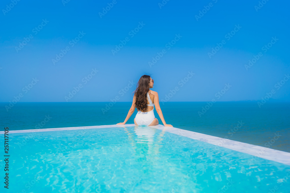 Portrait beautiful young asian woman happy smile relax in swimming pool for travel vacation Portrait beautiful young asian woman happy smile relax in swimming pool for travel vacation