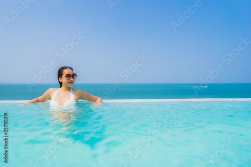 Portrait beautiful young asian woman happy smile relax in swimming pool for travel vacation © siraphol