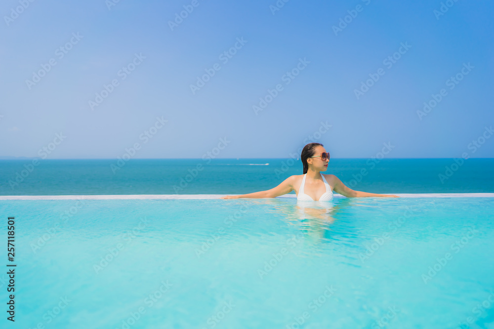 Portrait beautiful young asian woman happy smile relax in swimming pool for travel vacation Portrait beautiful young asian woman happy smile relax in swimming pool for travel vacation