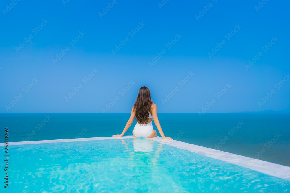 Portrait beautiful young asian woman happy smile relax in swimming pool for travel vacation